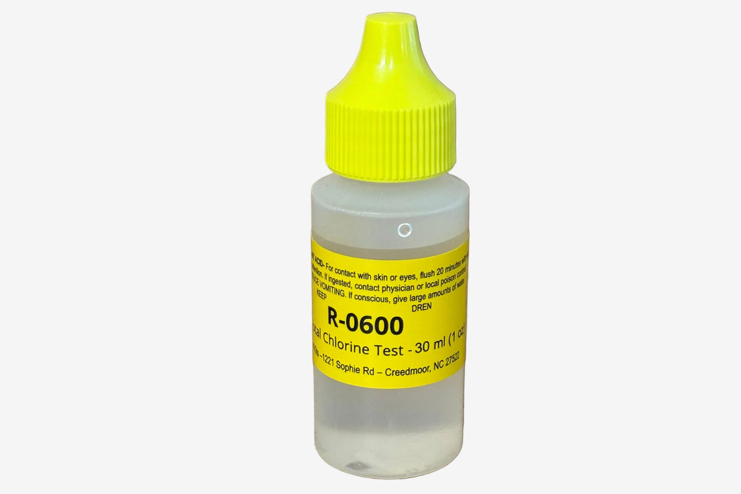 A small plastic bottle of chlorine test reagent with a bright yellow cap and a yellow label, standing on a wooden tabletop.